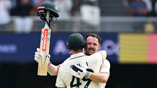 Travis Head celebrates his century with Smith.