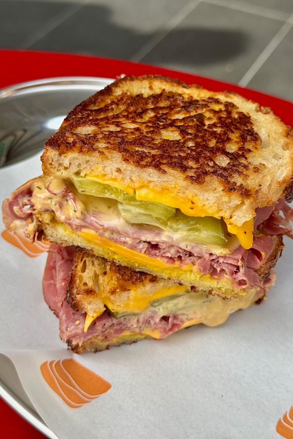 Smoked wagyu beef with pickles and melted cheese.