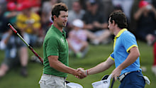 Rory McIlroy, right, of Northern Ireland shakes hands with Australia’s Adam Scott.