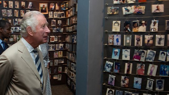 Prince Charles looks at photographs of some of those who died, at the Kigali Genocide Memorial in Kigali, Rwanda.