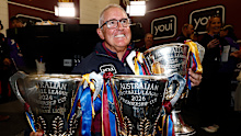 Brisbane coach Chris Fagan with the last three premiership cups. 