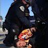 A protester is arrested by California Highway Patrol near the federal building in downtown Los Angeles on Tuesday.