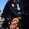 A protester is arrested by California Highway Patrol near the federal building in downtown Los Angeles on Tuesday.