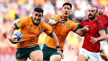 Izaia Perese of Australia breaks with the ball at Stade Geoffroy-Guichard.