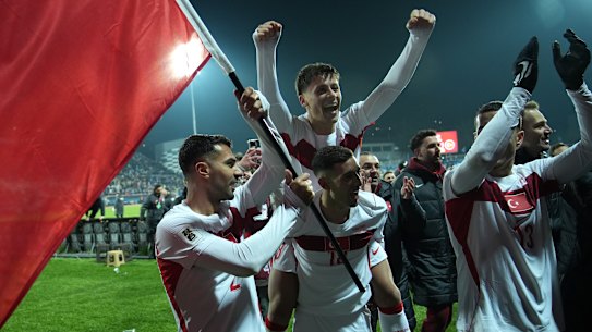 Zeki Celik, Arda Guler and Mert Muelduer celebrate Turkey’s qualification for the World Cup.