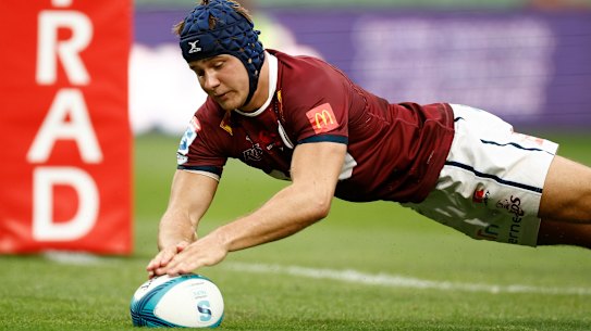 Josh Flook of the Reds scores a try during the round 2 contest.