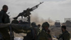 Israeli army troops are seen on the Israeli-Gaza border during a ground operation in the Gaza Strip. in November.