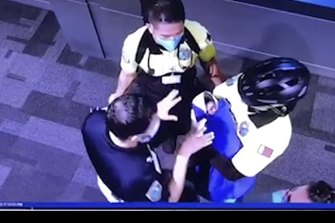 A surveillance image, obtained by Doha News,  shows officials holding an allegedly abandoned baby at Hamad International Airport. 