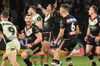 Jackson Hastings turns to celebrate as Luke Brooks sinks South Sydney with a field goal on Saturday night.