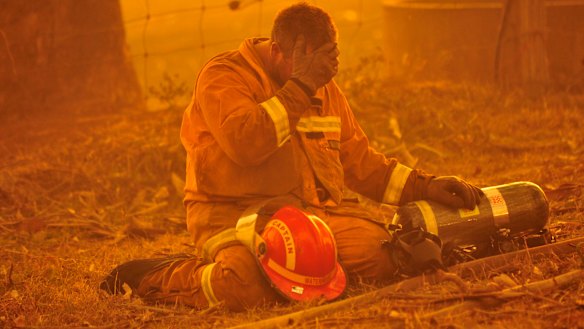 A fireman takes a breather as the the bushfire rages towards the townships of Labertouche and Tonimbuk. 