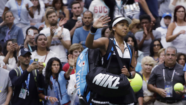 Naomi Osaka waves to the crowd after her US Open loss.