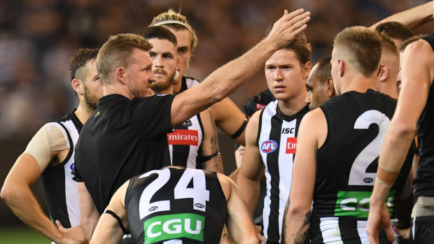 Nathan Buckley (second from left) during the round one match between Collingwood and Geelong. 