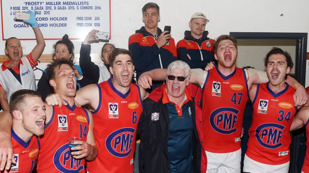 Port coach Gary Ayres sings the club song with his players after beating Footscray.