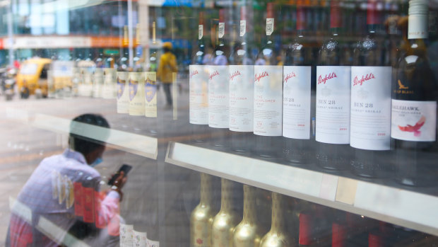 A man sits outside a wine shop that sells Australian wines in eastern Beijing’s Tongzhou district. 