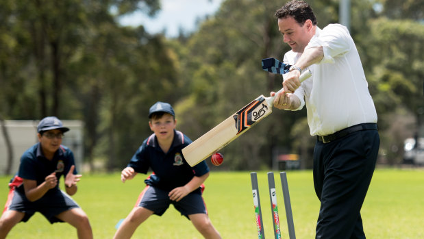 NSW Sports Minister Stuart Ayres plays with young cricketers at the Wilson Park announcement.