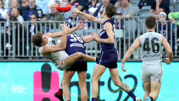 Backed up: Carlton's Charlie Curnow gets tangled in a contest against Docker Luke Ryan.