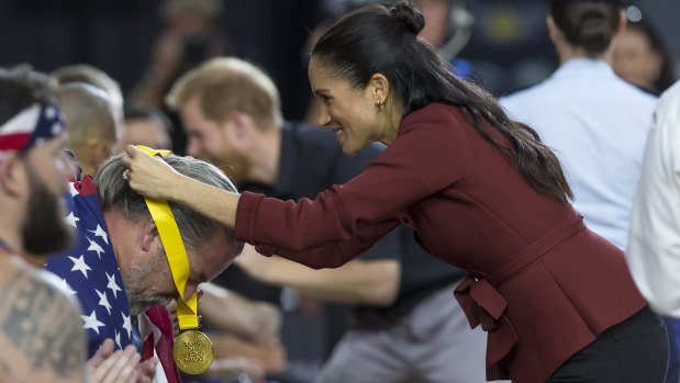 Meghan, the Duchess of Sussex, presents a medal following the wheelchair basketball final at the Invictus Games.