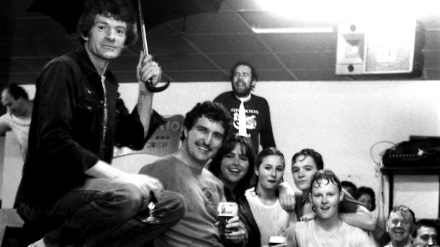 Patrons in the flooded bar of the Haymarket Hotel make the best of it.
