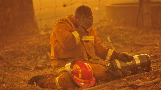 A fireman takes a breather as the the bushfire rages towards the townships of Labertouche and Tonimbuk. Black Saturday.
