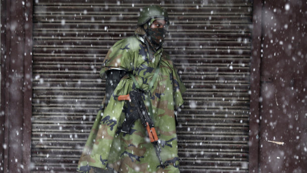 An Indian paramilitary soldier stands guard in the snow in Srinagar, Indian controlled Kashmir.