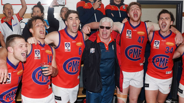 Port coach Gary Ayres sings the club song with his players after beating Footscray.