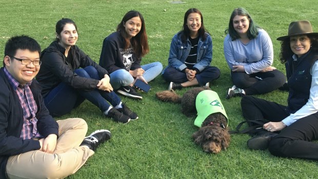 Roz Rimes with her dog Flash and students at the University of Melbourne.