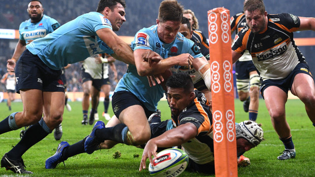 Close: Folau Fainga'a of the Brumbies attempts to plant the ball in the corner.