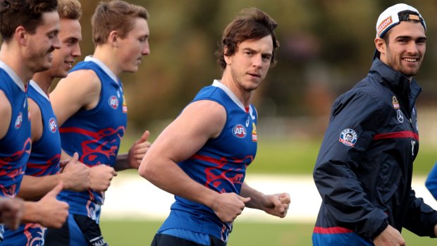 Jury still out: Liam Picken, centre, warms up at a training session at the Whitten Oval, but his health remains a concern.