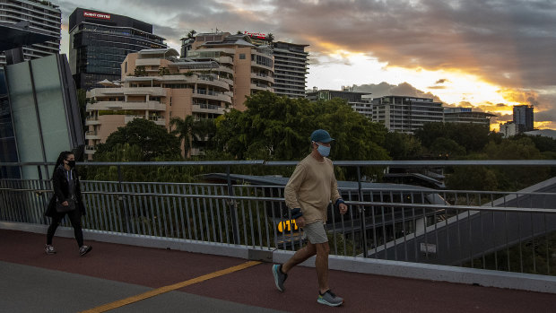 A mask-wearing pedestrians on the Goodwill Bridge near Southbank in the heart of Brisbane.
