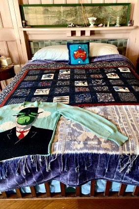 Martin Sharp's bed surrounded by a mix of bourgeois china ornaments and eclectic pop art.