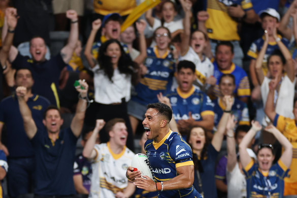 Will Penisini celebrates the Eels’ opening try with the crowd at CommBank Stadium.