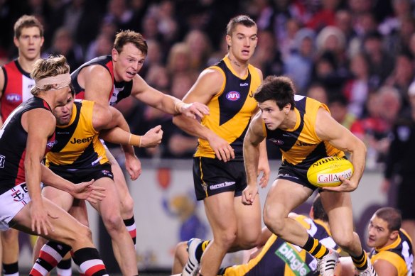 Richmond’s Trent Cotchin looks for a way around the pack at Etihad.