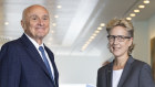 Professor Allan Fels hands over the report into Price Gouging and Unfair Pricing Practices to ACTU secretary Sally McManus at Parliament House.