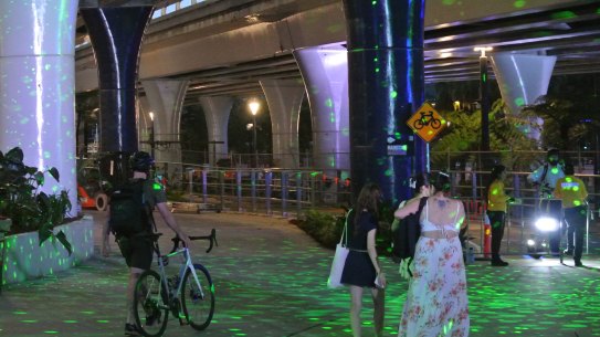 Cyclists and e-scooter users were asked to walk through the Sono Lumo light show, in the middle of the Bicentennial Bikeway.
