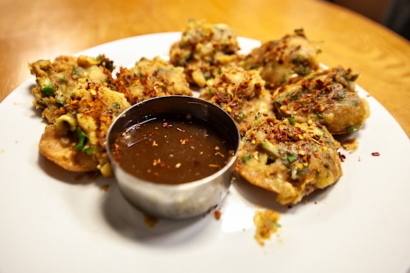 Golden fried discs of dal puri served with crushed lentils and tamarind water.
