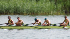 A disappointed Aussie eight crew slumps in the background as Team GB celebrate their gold.