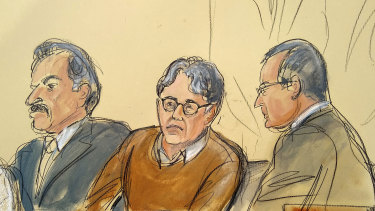 Defendant Keith Raniere, centre, is seated between his attorneys Paul DerOhannesian, left, and Marc Agnifilo during the first day of his sex trafficking trial.