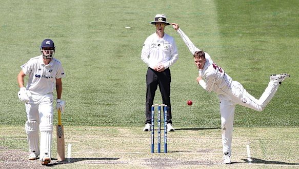 Matthew Kuhnemann bowls for Queensland against Victoria at the MCG.