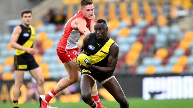 Crouching Tiger: Mabior Chol breaks through the Swans defence during the round 6 clash at The Gabba in Brisbane.