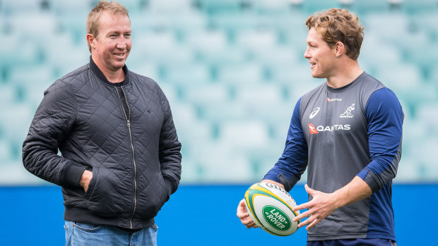 Trent Robinson chews the fat with Michael Hooper at Wallabies training on Thursday. 