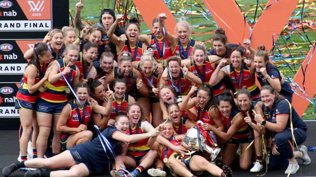 Crows' feat: Adelaide players celebrate their AFLW grand final triumph.