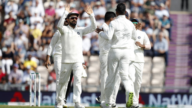 Got 'im: India's Virat Kohli (left) celebrates with teammates after Alastair Cook's dismissal.