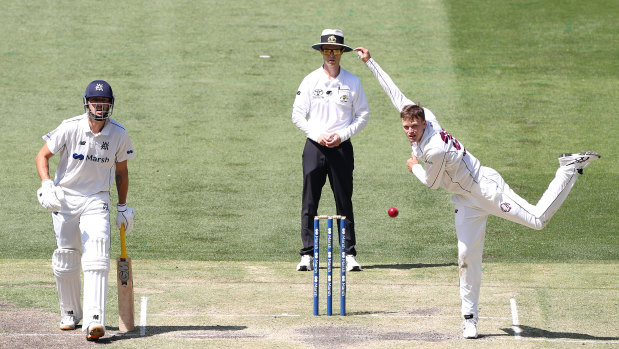 Matthew Kuhnemann bowls for Queensland against Victoria at the MCG.