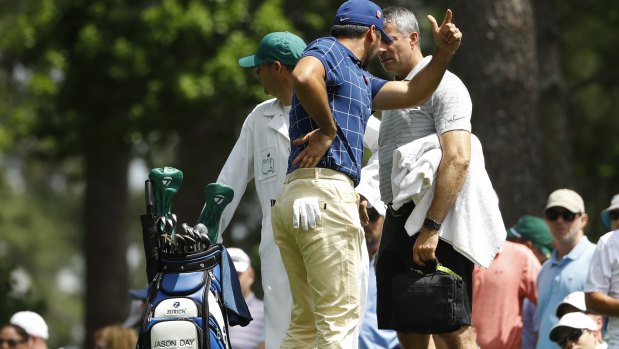 Jason Day holds his back on the fourth tee at Augusta during the first round.