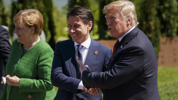 US President Donald Trump, right, shakes hands with Italian PM Giuseppe Conte at the G7 in Quebec, Canada, in June.
