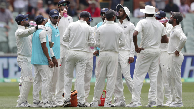Upbeat: India enjoy a drinks break at Adelaide Oval on Friday.