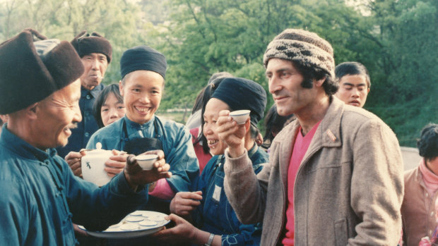 Arnold Zable drinking tea in China with tribespeople near Huaxi in Guizhou Province.