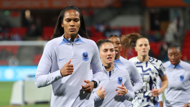 French captain Wendie Renard leads the warm-up.
