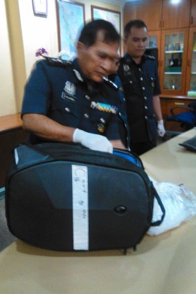 Director of Customs at Malaysia's international airport, shows the bag allegedly containing drugs that was being carried by Maria Elvira Pinto Exposto when she was arrested.