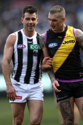 Dustin Martin shares a word with his shadow for the day, Magpies tagger Levi Greenwood.